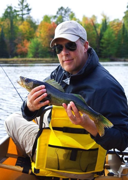 happy-fisherman-holds-up-a-walleye-on-a-northern-m-DN2SM64-resize.jpg